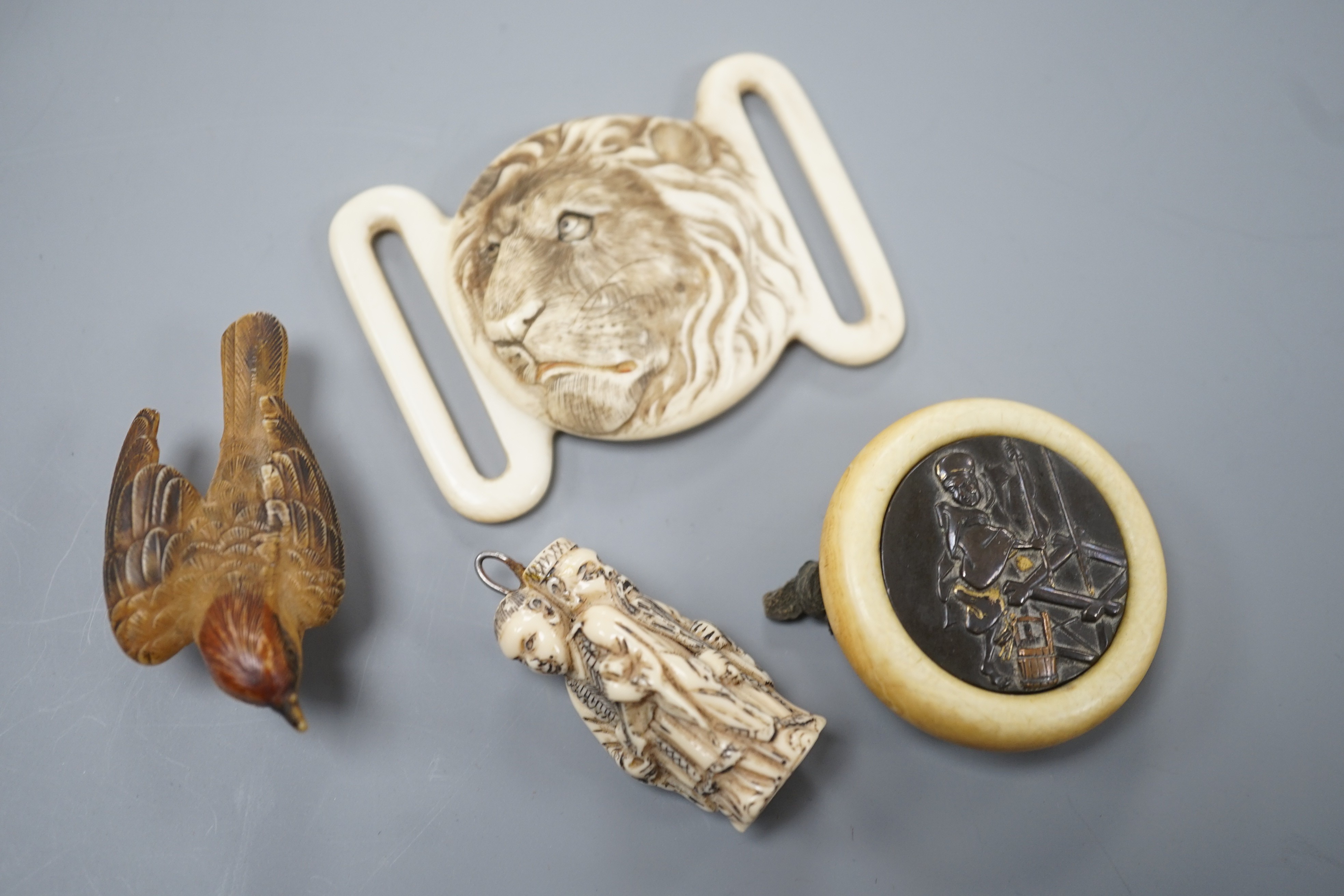 Two Japanese lacquer boxes, an ivory and bronze manju, an ivory ‘lion’ two-piece belt buckle and two simulated ivory items, late 19th/early 20th century, largest Box 11.5 cm